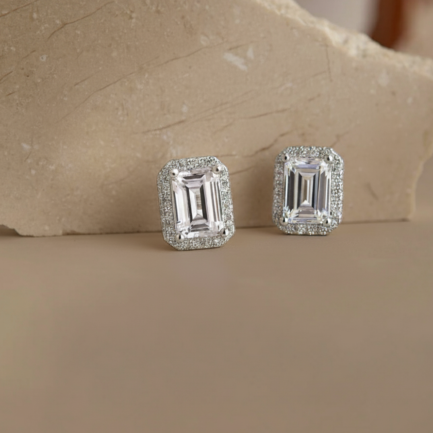 Pair of diamond earrings on a stone surface